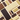 A professional product photograph showcases a row of Venchi chocolate bars standing vertically against a deep chocolate-brown background.