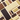 A professional product photograph showcases a row of Venchi chocolate bars standing vertically against a deep chocolate-brown background.