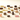 Assorted gourmet chocolates and truffles in various shapes, colors, and flavors are arranged on a light, cream-colored surface. Some pieces have glossy finishes, while others appear textured or layered.