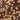 Close-up of a chocolate bar with whole and halved hazelnuts embedded in the smooth, glossy dark chocolate surface. The chocolate has visible diagonal cracks and a rich, brown color.