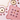 Flat lay of pink and purple macarons, unwrapped chocolates, and gold plates on a light pink surface decorated with wavy-edged white and pink placemats with gold and red trim. - AI generated text