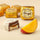 A Chocoviar Mango chocolate, adorned with delicate white cocoa granules and gold foil, beside a slice of fresh mango. - AI generated text