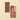 A 2.75 oz milk chocolate bar with caramel notes rests beside its elegant brown-orange packaging on a refined beige backdrop. - AI generated text
