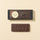 A crisp, rippled Dark Chocolate ChocoBiscuit snack bar displayed beneath its elegant black rectangular packaging. - AI generated text