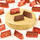Two unwrapped Gianduiotto 1878 Vegan chocolates on a gold pedestal, nestled among pieces in elegant red foil. - AI generated text
