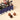 Navy blue Vintage Dream Train tin containing Cream & Crunchy Small, foil-wrapped chocolates, and three chocolate spheres. - AI generated text