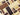 Assorted chocolate bars in various sizes, shapes, and colors—dark, milk, and white—arranged neatly in a grid pattern on a beige background. - AI generated text