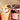 Two Venchi dessert cups filled with whipped cream, sauces, and topped with chocolate discs; the left cup features caramel, while the right has a berry sauce and chocolate pieces. Both are branded with the Venchi logo. - AI generated text