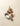 A variety of chocolates, nuts, and candy pieces are artfully arranged on a beige surface, including chocolate eggs, nuts, chocolate chunks, and a piece of blue candy with a cracked shell. - AI generated text