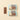 A Milk ChocoBiscuit Snacks Bunde bar and six elegantly wrapped gluten-free bars rest on a beige background. - AI generated text