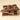Three glossy bars from the Milk Bars Bundle, embossed with VENCHI, are stacked together, showcasing rich toffee caramel notes on a light beige background.