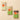 Three Venchi pistachio bars elegantly arranged on a warm beige surface, reflecting Italian artistry and refined simplicity. - AI generated text